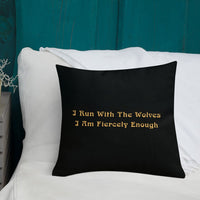 Black STRONG WOLF PILLOW with WRITING ON BACK | I Am Enough Collection - It says: "I run with the wolves, I am fiercely enough." It's sitting on a white sofa with a teal background.